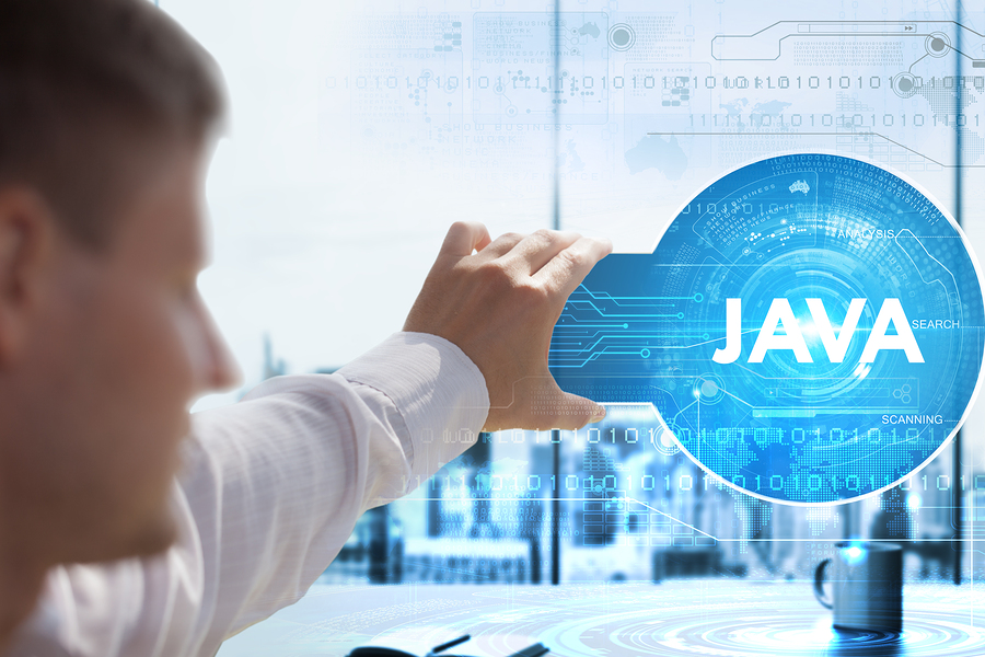 Developer pointing at the word Java on a technology screen